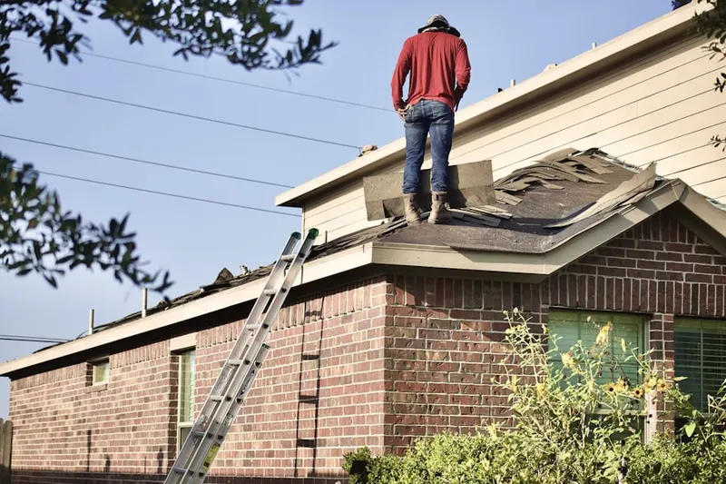 Professional roofer working on a residential roof in Hague